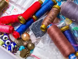 Spools of coloured thread and embroidery notions